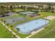 A high-angle view of the sports courts features tennis, basketball, and hockey, surrounded by manicured lawns and lush landscaping at 2359 Baronsmede Ct, Winter Garden, FL 34787