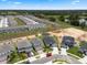 An aerial view of new homes and an available lot in a community, shot on a sunny day at 2372 Orchid Dr, Davenport, FL 33837
