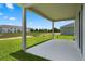 View from the back porch looks out over the lawn towards a pond and houses at 2372 Orchid Dr, Davenport, FL 33837
