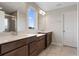 The primary bath is complete with dual vanities and a framed mirror, and tiled shower with glass door at 2372 Orchid Dr, Davenport, FL 33837