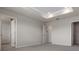 The bedroom features plush carpeting, neutral paint, tray ceiling, and an ensuite bathroom and walk-in closet at 2372 Orchid Dr, Davenport, FL 33837