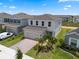 Two-story home with a charming brick driveway and well-maintained landscaping, offering suburban appeal at 2372 Orchid Dr, Davenport, FL 33837