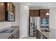A modern kitchen features stainless steel appliances, granite countertops, and ample cabinetry at 2372 Orchid Dr, Davenport, FL 33837