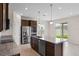 This kitchen features granite counters, an island, and stainless steel appliances at 2372 Orchid Dr, Davenport, FL 33837