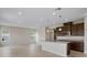 The open-concept kitchen features granite countertops, stainless steel appliances, and a large island at 2372 Orchid Dr, Davenport, FL 33837