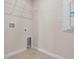 A compact laundry room featuring tile flooring and utility connections at 2372 Orchid Dr, Davenport, FL 33837