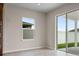 This light-filled living space features tile floors and access to a patio at 2372 Orchid Dr, Davenport, FL 33837