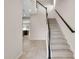 Bright foyer with tiled flooring and staircase, offering access to the home's upper level and kitchen at 2372 Orchid Dr, Davenport, FL 33837
