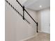 The house features a staircase with white railings and dark wooden banisters near the main entry at 2372 Orchid Dr, Davenport, FL 33837
