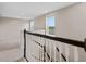 View of the staircase landing with black and white railing, offering view of surrounding nature at 2372 Orchid Dr, Davenport, FL 33837