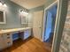 Bathroom with double sinks, modern lighting, plantation shutters, and access to en-suite bedroom at 2548 Galliano Cir, Winter Park, FL 32792