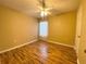 Bedroom featuring hardwood floors, a ceiling fan, and white curtains allowing natural light to filter through at 2548 Galliano Cir, Winter Park, FL 32792
