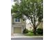 Charming townhome with a one-car garage, complemented by mature trees and lush landscaping at 2548 Galliano Cir, Winter Park, FL 32792