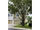 Charming townhome featuring a one-car garage, mature trees, and a well-manicured front yard at 2548 Galliano Cir, Winter Park, FL 32792