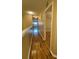 Hallway with hardwood floors leading to a bedroom and an open concept space with bright sunlight and plantation shutters at 2548 Galliano Cir, Winter Park, FL 32792