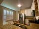 Kitchen with stainless steel fridge, granite countertops, white cabinets, and plantation shutters at 2548 Galliano Cir, Winter Park, FL 32792