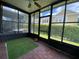 Enclosed lanai features wood-like flooring and views of the exterior yard at 2548 Galliano Cir, Winter Park, FL 32792