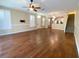 Bright and open living area with hardwood floors, plantation shutters, and staircase access at 2548 Galliano Cir, Winter Park, FL 32792
