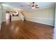 Spacious living room with hardwood floors, neutral walls, ceiling fan, and staircase access at 2548 Galliano Cir, Winter Park, FL 32792
