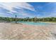 An inviting community pool surrounded by a spacious patio and swaying palm trees for relaxation and enjoyment at 2927 Elio Hammock Dr, St Cloud, FL 34773