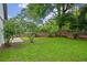 Backyard featuring lush green grass and mature trees at 3107 Ash Park Loop, Winter Park, FL 32792