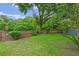 Grassy backyard with privacy features and mature trees at 3107 Ash Park Loop, Winter Park, FL 32792