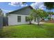 Backyard view featuring a well-maintained lawn and privacy fence at 3107 Ash Park Loop, Winter Park, FL 32792
