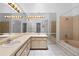 Bright bathroom featuring double sinks, a bathtub, and large mirrors at 3107 Ash Park Loop, Winter Park, FL 32792