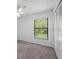 Bright bedroom with a view of lush greenery through the window at 3107 Ash Park Loop, Winter Park, FL 32792