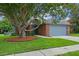 Well-kept single-Gathering home with lush lawn, mature trees, and classic brick and siding exterior at 3107 Ash Park Loop, Winter Park, FL 32792