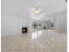Spacious living room with tile flooring, fireplace, and a wall of mirrors reflecting natural light at 3107 Ash Park Loop, Winter Park, FL 32792