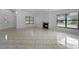 Inviting living area featuring tile floors, a cozy fireplace, and large windows for natural light at 3107 Ash Park Loop, Winter Park, FL 32792
