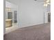Spacious living room with neutral carpet, ceiling fan, and view to kitchen area at 3107 Ash Park Loop, Winter Park, FL 32792