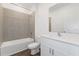 Modern bathroom featuring a tub with tile surround, white vanity with a bright countertop at 3144 Suraj Cir, Tavares, FL 32778