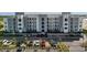 Modern apartment complex featuring a parking lot and well maintained landscaping at 3191 Paradox Cir # 102, Kissimmee, FL 34746