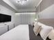Bright, minimalist bedroom features modern lighting and stylish, neutral decor at 3191 Paradox Cir # 102, Kissimmee, FL 34746