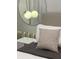 Cozy bedroom detail showcasing modern light fixture and designer pillows at 3191 Paradox Cir # 102, Kissimmee, FL 34746