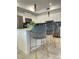 Contemporary kitchen featuring stylish bar stools, modern appliances, and sleek cabinets at 3191 Paradox Cir # 102, Kissimmee, FL 34746