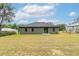 View of the backyard with sliding glass doors to the patio at 327 Larch Rd, Ocala, FL 34480