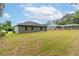 The backyard features a grassy lawn and a screened swimming pool at 327 Larch Rd, Ocala, FL 34480