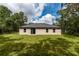 Exterior view of the back of the home with a spacious yard at 327 Larch Rd, Ocala, FL 34480