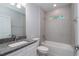 Bathroom featuring tub with shower, window, granite countertop, and white cabinetry at 327 Larch Rd, Ocala, FL 34480