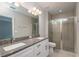 Bathroom with double sink vanity, granite counters, and tiled walk-in shower at 327 Larch Rd, Ocala, FL 34480