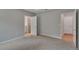 Spacious bedroom features carpeted floors, neutral paint, and two access doors to closets and bathrooms at 327 Larch Rd, Ocala, FL 34480
