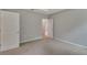 Carpeted bedroom with neutral colors, two entry doors, and bright natural light at 327 Larch Rd, Ocala, FL 34480
