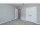 Neutral bedroom with gray walls, carpet, and white closet and entry doors at 327 Larch Rd, Ocala, FL 34480