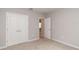 Neutral bedroom with gray walls, carpet, and white closet and entry doors at 327 Larch Rd, Ocala, FL 34480