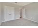 Neutral bedroom features carpeted floors and a double-door closet at 327 Larch Rd, Ocala, FL 34480