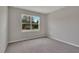 Comfortable bedroom features a large window overlooking mature trees at 327 Larch Rd, Ocala, FL 34480