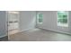 Bright bedroom with neutral carpeting and two windows for natural light at 327 Larch Rd, Ocala, FL 34480